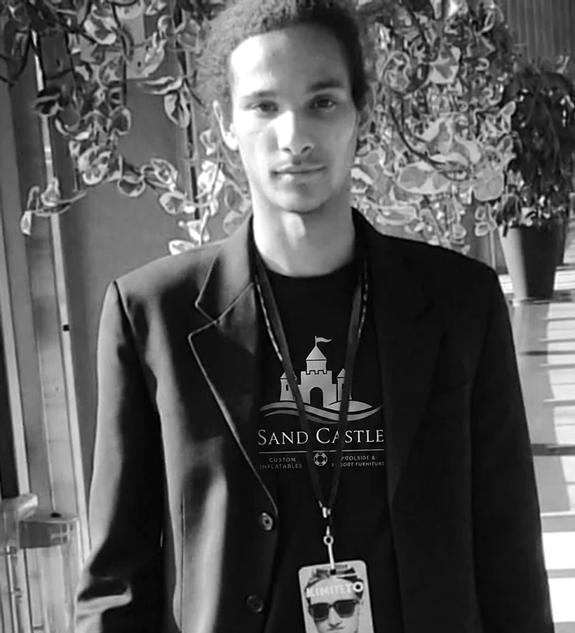 Tyron Fandal on the trade show floor, wearing a Sand Castle shirt and an exhibitor badge